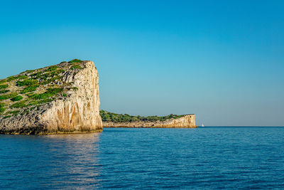 Scenic view of sea against clear blue sky