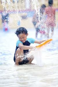 Boy playing in swimming pool