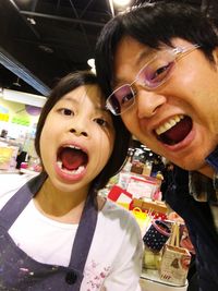 Close-up portrait of happy woman with baby at home