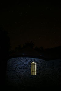 Lifeguard hut against sky at night