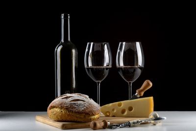 Close-up of wine glass on table against black background