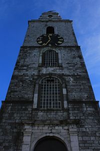 Low angle view of bell tower against sky