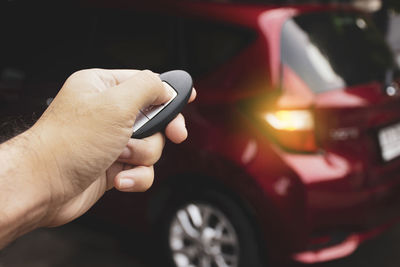 Midsection of man using mobile phone