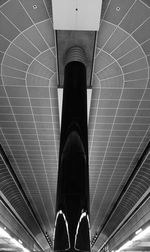 Low section of person standing on metal floor