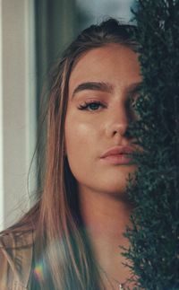 Close-up portrait of young woman at home