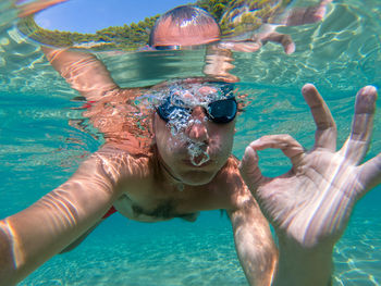 High angle view of man swimming in sea