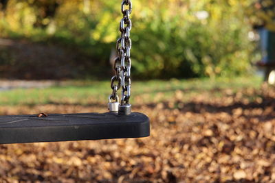 Close-up of swing hanging at playground