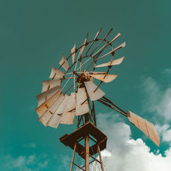 Low angle view of traditional windmill against blue sky