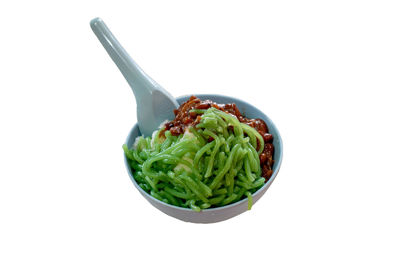 Close-up of fresh vegetables in bowl against white background