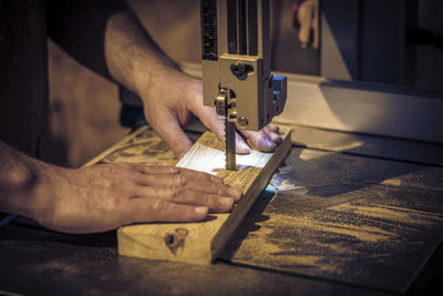 Close-up of man working on wood