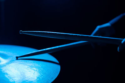 Close-up of blue light on table against black background