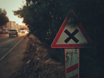 Close-up of road sign against trees