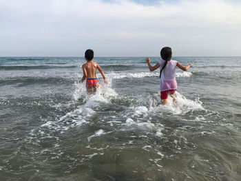 People on beach against sky