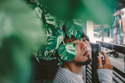 Close-up of young man smoking cigarette