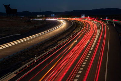 High angle view of light trails on highway at night