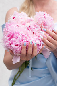 Bride in a blue wedding dress with a bouquet of pink peonies, pastel paradise