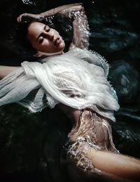 Portrait of young woman in water