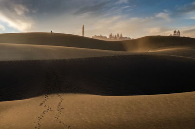 Scenic view of desert against sky during sunset