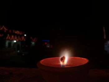 Close-up of lit tea light candles on table