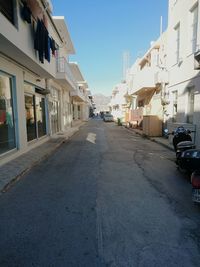 View of city street against blue sky