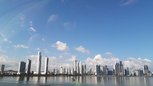 Panoramic view of sea and buildings against sky