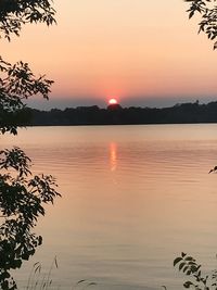 Scenic view of lake against orange sky