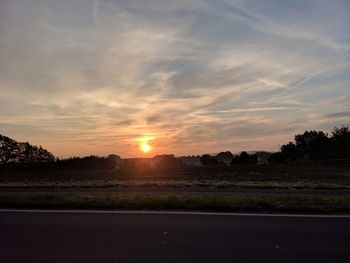 Scenic view of field against sky during sunset