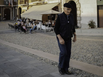 Full length of man standing against built structure