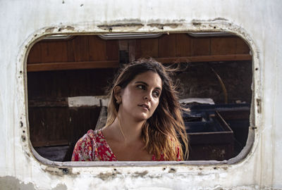 Thoughtful woman seen through vehicle window