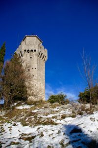 Low angle view of castle against clear blue sky