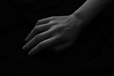 Close-up of hand against black background