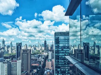 Skyscrapers against cloudy sky