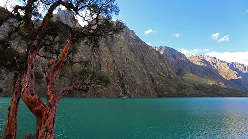 Scenic view of sea and mountains against sky