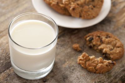 Close-up of cookies by milk on table