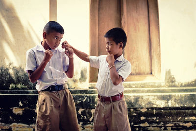 Male students fighting against building