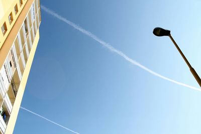 Low angle view of street light against blue sky