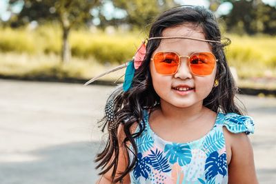 Portrait of smiling girl wearing sunglasses