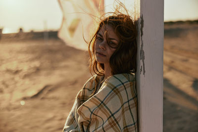 Portrait of young woman standing outdoors