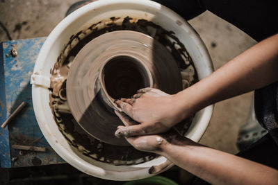 Close-up of artist making pot at workshop