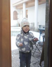 Portrait of cute girl standing in snow