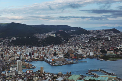 High angle view of townscape by sea against sky