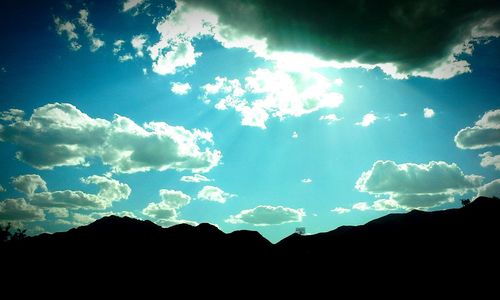 Scenic view of mountains against cloudy sky