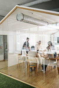 Business meeting in conferene room behind glass wall