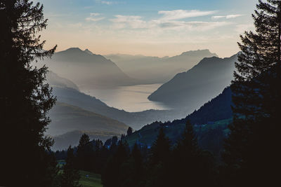 Scenic view of silhouette mountains against sky at sunset