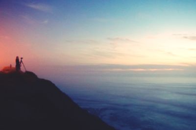 Silhouette of sea against sky during sunset