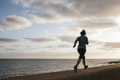 Girl exercising near the sea