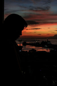 Silhouette of woman at sunset