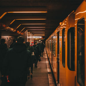 Rear view of people waiting at train