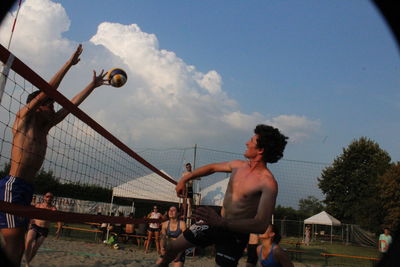 Man playing soccer against sky