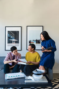 Business colleagues discussing over documents in office